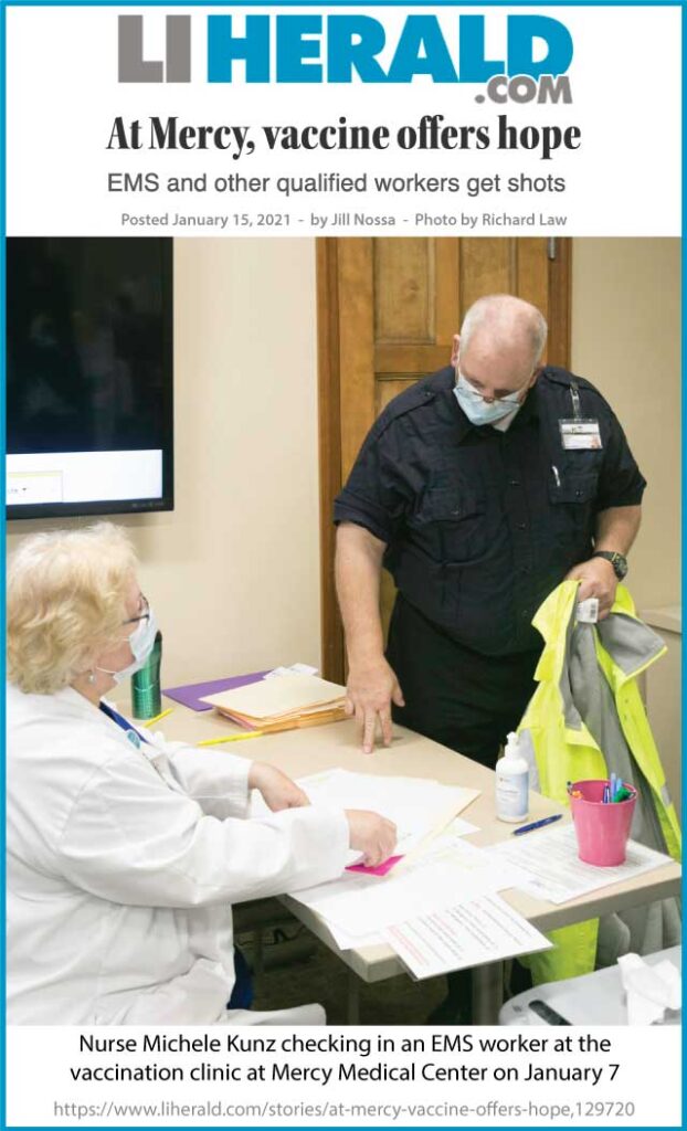 Photo: Nurse Michele Kunz checking in an EMS worker at the vaccination clinic at Mercy Medical Center on January 7